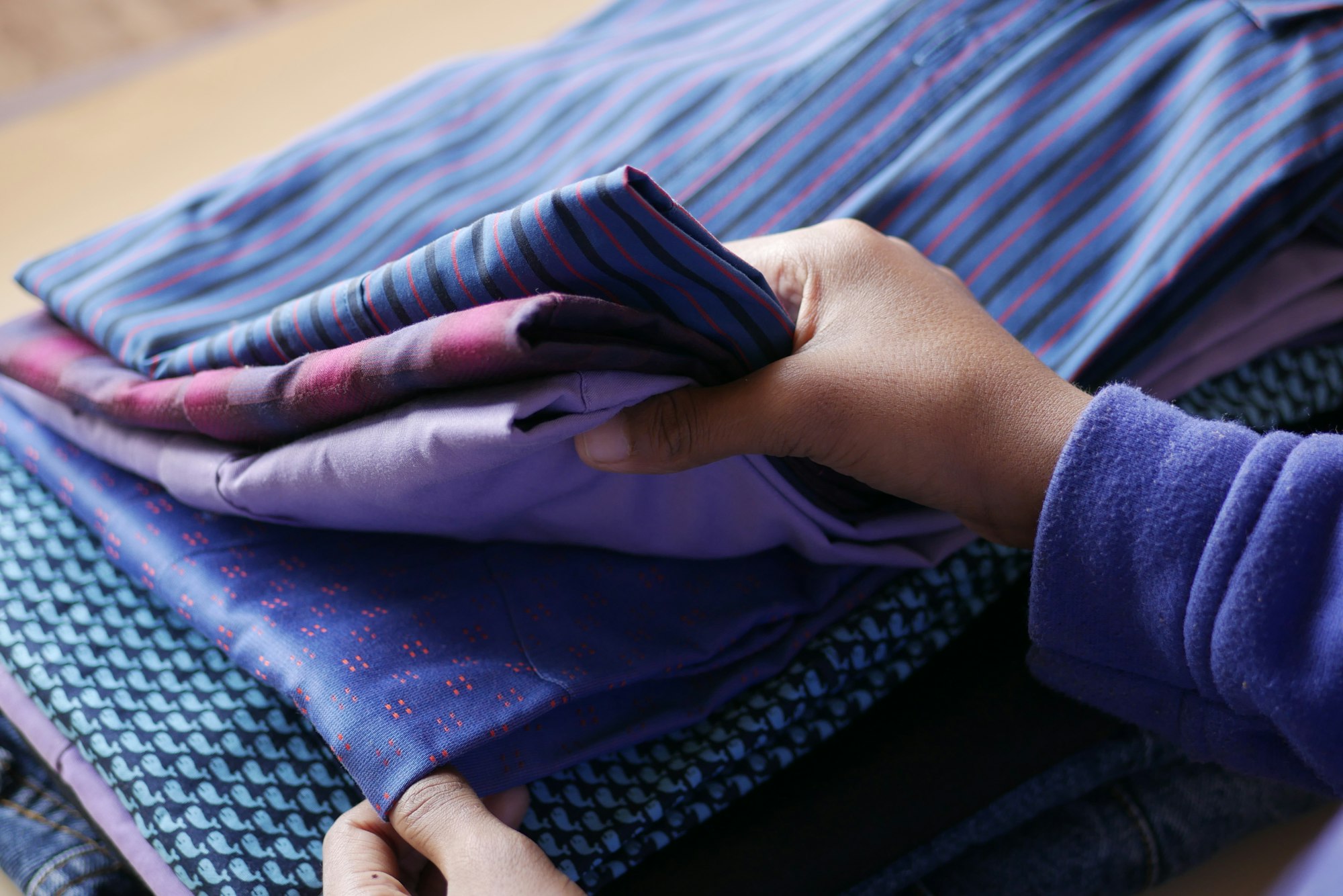 Close up of stack of cloths on table.